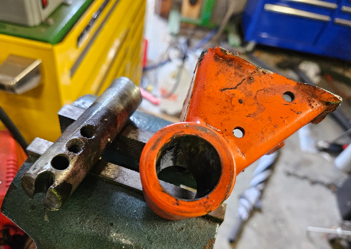 25 08 21 kubota mower anti scalp wheel support off mower next to removed shaft small.jpg
